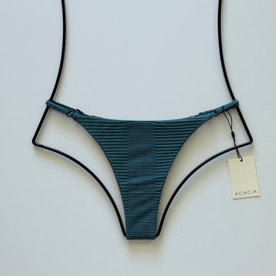 ront flat lay of Acacia Swimwear Ralphy Dual Ribbed Bikini Bottom in Horizon – teal-blue ribbed texture with Acacia hangtag visible.