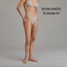 Model wearing Acacia Ralphy Bikini Bottom showing high-cut leg and minimal coverage fit.