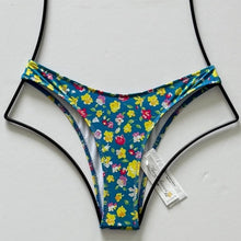 Heavy Manners High Cut Cheeky Bikini Bottom in Mercer St. floral print – blue base with colorful yellow, red, and pink flowers, minimal coverage swim bottom, size XS and Large available.