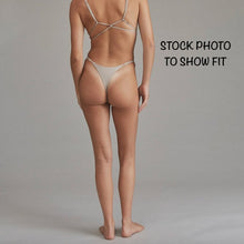 Back view of model wearing Acacia Ralphy Bikini Bottom highlighting cheeky fit and adjustable side straps.
