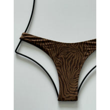 Close-up of Neutral Mares pattern showing tonal brown zebra-like design and smooth lining texture.