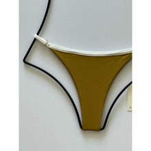 Close-up detail of ribbed fabric and piping on Acacia Swimwear Neema Piped Ribbed Bikini Bottom in Miso.