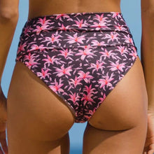 Model wearing Acacia Echo bikini bottom in Madonna print – high waist, cheeky cut with tropical floral print.