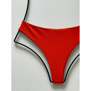 Close-up of Acacia Swimwear Brazil ribbed bikini bottom in persimmon orange – ribbed texture detail