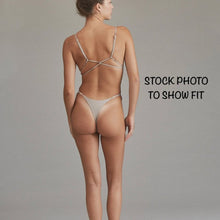 Model wearing Acacia Ralphy Bikini Bottom viewed from the back, showing cheeky minimal coverage fit.